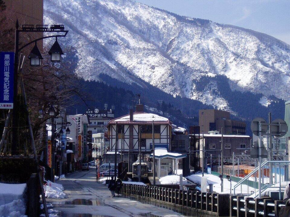石畳の路地と軒灯の列、湯気の続く夜の散歩道